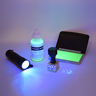ultraviolet flashlight,  wood handle stamp, UV ink, and UV pad
